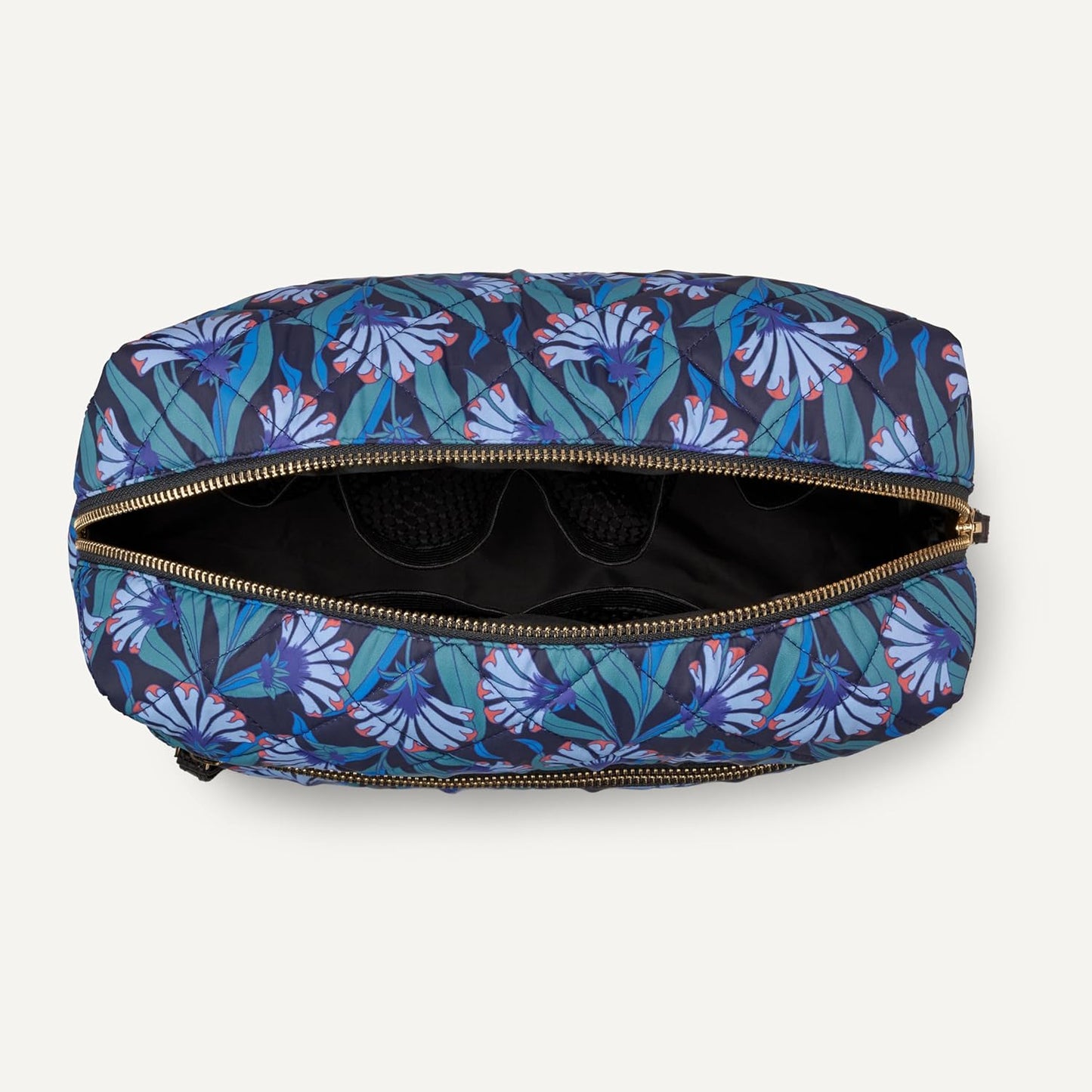 Top view of open quilted floral bag with interior pockets