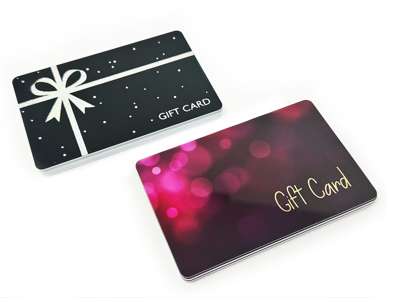 Two custom gift cards with silver bow and pink bokeh